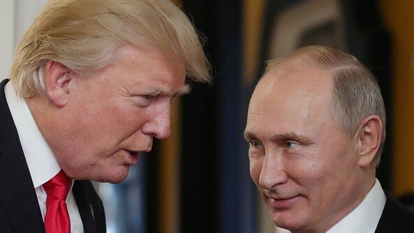 US President Donald Trump (L) chats with Russia's President Vladimir Putin as they attend the APEC Economic Leaders' Meeting, part of the Asia-Pacific Economic Cooperation (APEC) leaders' summit in the central Vietnamese city of Danang on November 11, 2017. (Photo by Mikhail KLIMENTYEV / SPUTNIK / AFP) (Photo by MIKHAIL KLIMENTYEV/SPUTNIK/AFP via Getty Images)