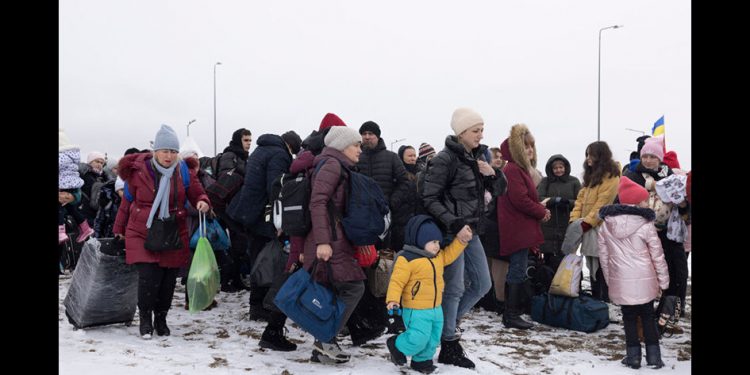 KRAKOVETS, UKRAINE - MARCH 09: Refugees fleeing conflict make their way to the Krakovets border crossing with Poland on March 09, 2022 in Krakovets, Ukraine. More than a million people have fled Ukraine following Russia's large-scale assault on the country, with hundreds of thousands of Ukrainians passing through Lviv on their way to Poland. (Photo by Dan Kitwood/Getty Images)