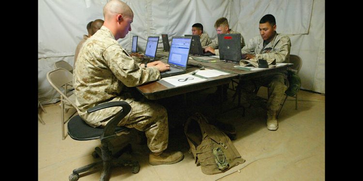AL ASAD, IRAQ - MAY 19: U.S. Marines from the 2nd Battalion, 7th Marines use free internet at the Morale, Welfare and Recreation Tent on May 19, 2004 at the Al Asad Airbase in Al Asad, Iraq. US Marines continue to patrol the military main supply route between Fallujah and Al Asad while training the Iraqi Civil Defense Corp and Iraqi Police for the hand over scheduled for June 30. (Photo by Justin Sullivan/Getty Images)