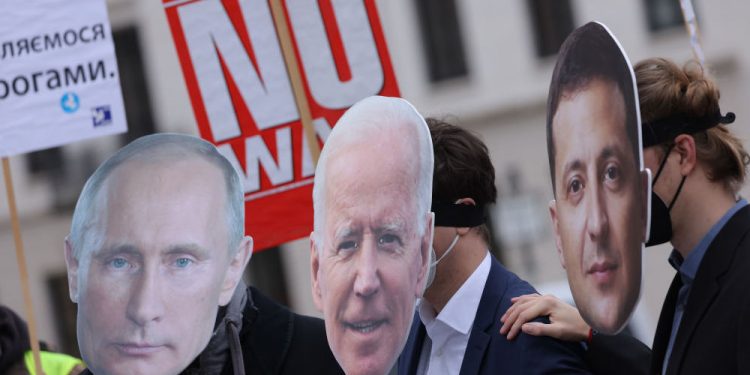 BERLIN, GERMANY - FEBRUARY 09: Protesters dressed as Russian President Vladimir Putin (L), U.S. President Joe Biden (C) and Ukrainian President Volodymyr Zelensky attend a small rally to demand a diplomatic solution to the current threat of war in Ukraine on February 09, 2022 in Berlin, Germany. Russia has amassed thousands of troops along its border to Ukraine, causing international fears of a possibly imminent military invasion.  (Photo by Sean Gallup/Getty Images)