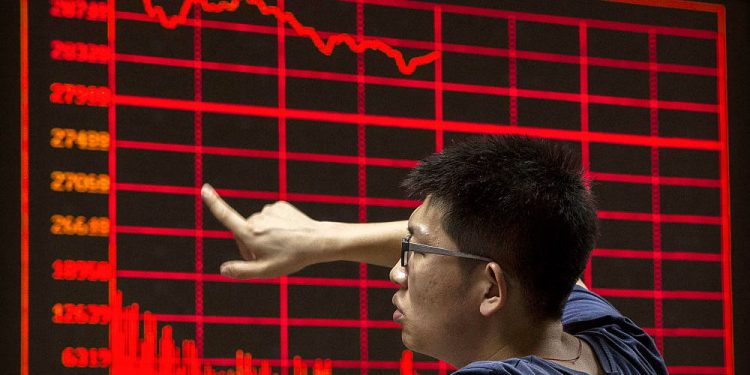 BEIJING, CHINA - AUGUST 27: A Chinese day trader reacts as he watches a stock ticker at a local brokerage house on August 27, 2015 in Beijing, China. A dramatic sell-off in Chinese stocks caused turmoil in markets around the world, driving indexes lower and erasing trillions of dollars in value. China's government has implemented a series of top-heavy measures to manipulate a market turnaround including its fifth cut to interest rates since November.æ But concerns about the overall health of China's economy remain amid data showing slower growth. (Photo by Kevin Frayer/Getty Images)