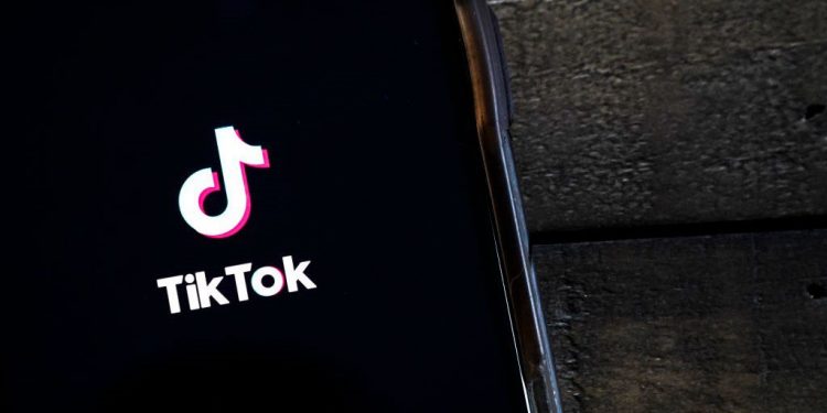 WASHINGTON, DC - AUGUST 07: In this photo illustration, the TikTok app is displayed on an Apple iPhone on August 7, 2020 in Washington, DC. On Thursday evening, President Donald Trump signed an executive order that bans any transactions between the parent company of TikTok, ByteDance, and U.S. citizens due to national security reasons. The president signed a separate executive order banning transactions with China-based tech company Tencent, which owns the app WeChat. Both orders are set to take effect in 45 days. (Photo Illustration by Drew Angerer/Getty Images)