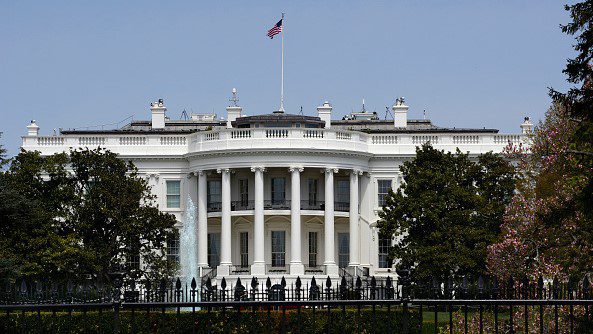 WASHINGTON, D.C. - APRIL 22, 2018: An American flag flies over the south facade of the White House in Washington, D.C. Additional security fences and barriers were added along the south perimeter to prevent people from jumping the fence and entering the restricted White House grounds. The Secret Service tightened the security on the south side in 2017 by closing access to the entire fence line on the South Lawn. (Photo by Robert Alexander/Getty Images)