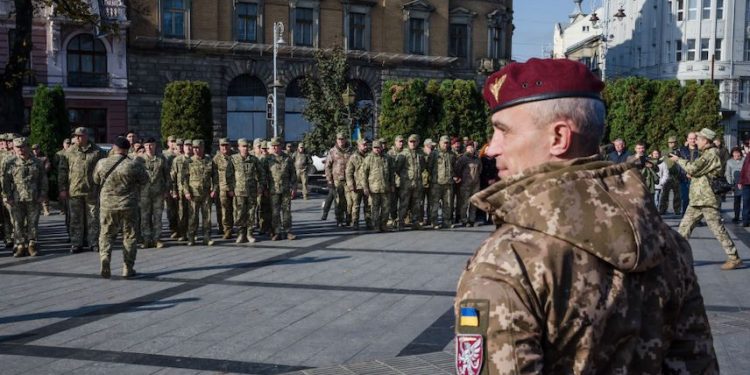 LVIV, UKRAINE - OCTOBER 14: People attend an award ceremony held by the Ministry of Defense of Ukraine to soldiers of various brigades who have returned from the combat zone or continue to defend their homeland on Ukraine Defender Day in Lviv, Ukraine on October 14, 2022. (Photo by Olena Znak/Anadolu Agency via Getty Images)