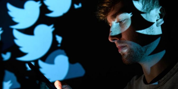 LONDON, ENGLAND - AUGUST 09: In this photo illustration, the logo for the Twitter social media network is projected onto a man on August 09, 2017 in London, England. With around 328 million users worldwide, Twitter has gone from a small start-up in for the public 2006 to a broadcast tool of politicians and corporations in 2017. (Photo by Leon Neal/Getty Images)