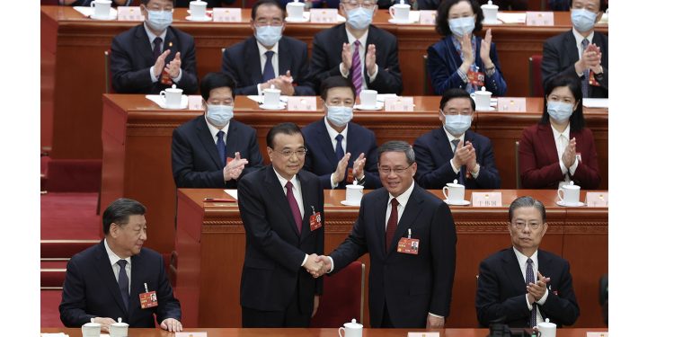 BEIJING, CHINA - MARCH 11: Former Chinese Premier (L2) Li Keqiang shakes hands with Chinese Premier Li Qiang(R) during the  fourth plenary session of the National People's Congress on March 11, 2023 in Beijing, China. China's annual political gathering, known as the Two Sessions, convenes the nation's leaders and lawmakers to set the government's agenda for domestic economic and social development for the next year. (Photo by Lintao Zhang/Getty Images)