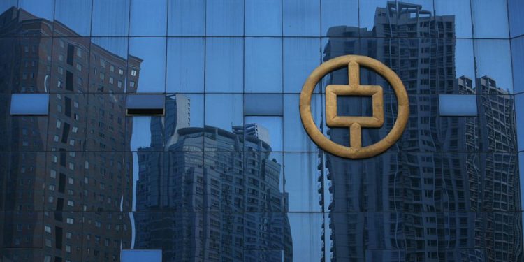 CHONGQING, CHINA - SEPTEMBER 29: (CHINA OUT) Buildings under construction are reflected on glass at the People's Bank of China office building on September 29, 2007 in Chongqing, China. The People's Bank of China and the China Banking Regulatory Commission have released new rules changing second residential home deposits from 40 percent from 30 percent in a move to curb soaring property prices. (Photo by China Photos/Getty Images)