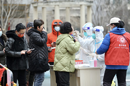 This photo taken on March 14, 2022 shows a resident underging a nucleic acid test for the Covid-19 coronavirus in Shenyang, in China's northeastern Liaoning province. - China OUT (Photo by AFP) / China OUT (Photo by STR/AFP via Getty Images)