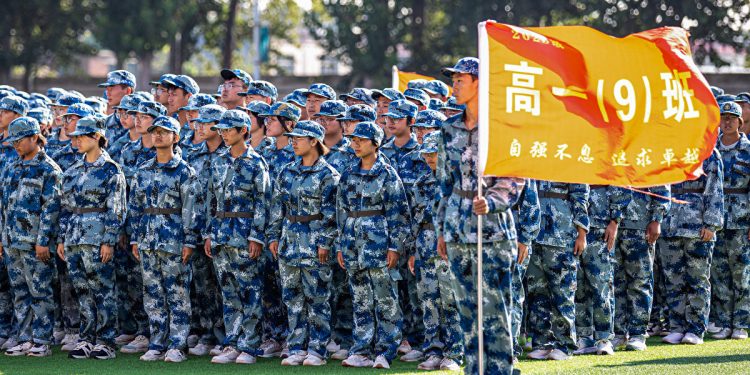 This photo taken on August 28, 2023 shows middle school students taking part in a ceremony during military training at their school in Anyang, in China's central Henan Province. (Photo by AFP) / China OUT