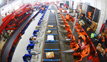 LIANYUNGANG, CHINA - NOVEMBER 12: Workers sort express parcels at a distribution center of an express enterprise after the Double 11 shopping festival on November 12, 2023 in Lianyungang, Jiangsu Province of China. (Photo by Geng Yuhe/VCG via Getty Images)
