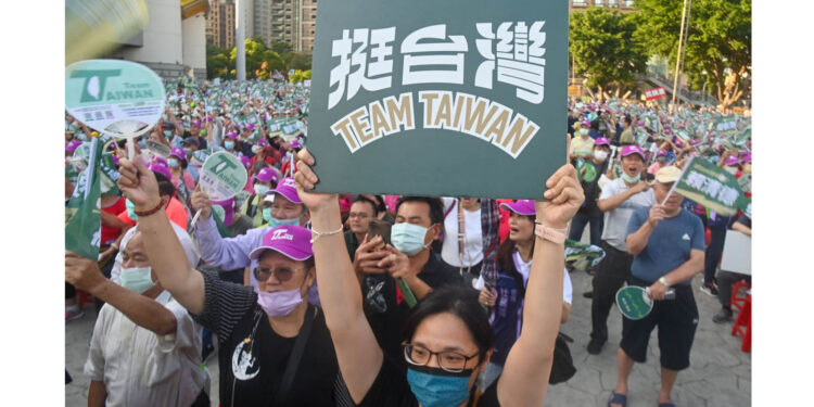 A supporter of Lai Ching-te, presidential candidate for 2024 from the ruling Democratic Progressive Party (DPP), displays a placard during a campaign rally in New Taipei City on November 4, 2023. (Photo by Sam Yeh / AFP) (Photo by SAM YEH/AFP via Getty Images)