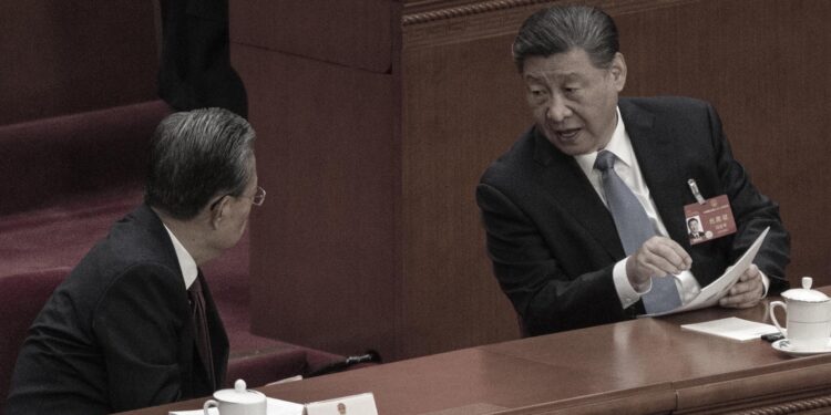 BEIJING, CHINA - MARCH 8: Chinese President Xi Jinping (R) speaks to NPC Chairman Zhao Leji during the second plenary session of the NPC, or National People's Congress, at the Great Hall of the People on March 8, 2024 in Beijing, China. China's annual political gathering known as the Two Sessions convenes leaders and lawmakers to set the government's agenda for domestic economic and social development for the year. (Photo by Kevin Frayer/Getty Images)