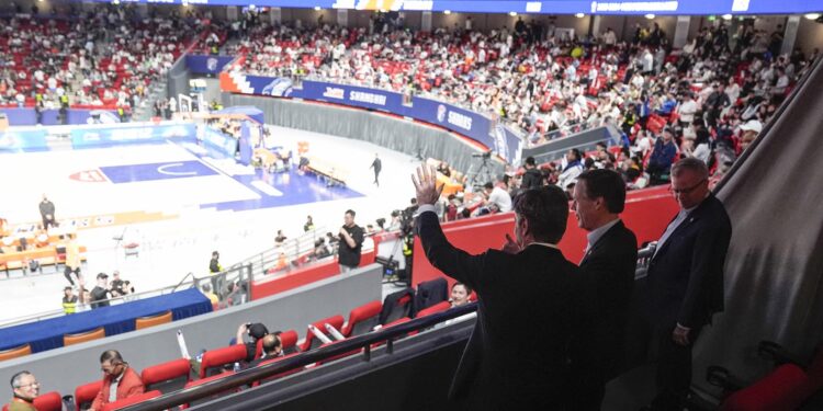 US Secretary of State Antony Blinken (L) waves next to US Ambassador to China Nicholas Burns (C) and US Consulate General in Shanghai Scott Walker (R) while attending a basketball game between the Shanghai Sharks and the Zhejiang Golden Bulls at the Shanghai Indoor Stadium in Shanghai on April 24, 2024. (Photo by Mark Schiefelbein / POOL / AFP) (Photo by MARK SCHIEFELBEIN/POOL/AFP via Getty Images)