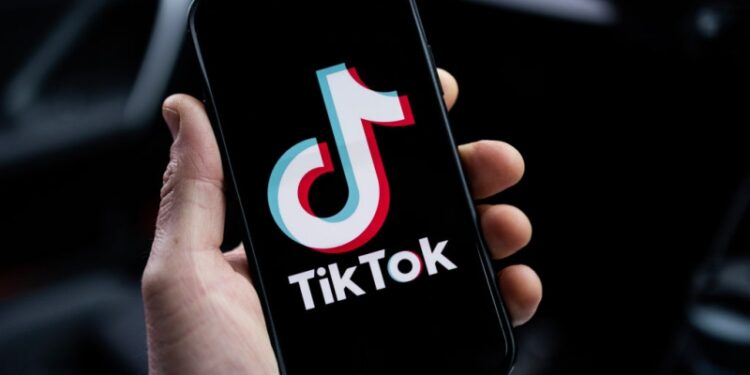 LONDON, ENGLAND - FEBRUARY 28: In this photo illustration, a TikTok logo is displayed on an iPhone on February 28, 2023 in London, England. This week, the US government and European Union's parliament have announced bans on installing the popular social media app on staff devices. (Photo by Dan Kitwood/Getty Images)