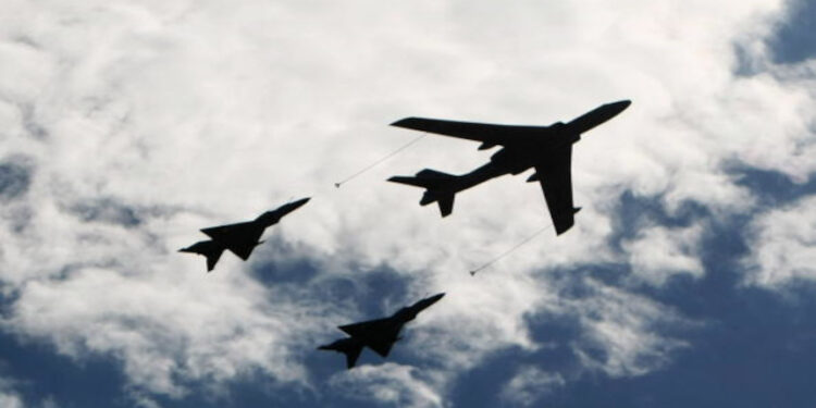 BEIJING - OCTOBER 01: Planes from the Chinese People's Liberation Army air force fly in formation during a massive parade to celebrate the 60th anniversary of the founding of the People's Republic of China on October 1, 2009 in Beijing, China. The grand celebrations to commemorate the 60th anniversary of the founding of the People's Republic of China included a military parade and mass pageant consisting of about 200,000 citizens in Tiananmen Square. (Photo by Feng Li/Getty Images)