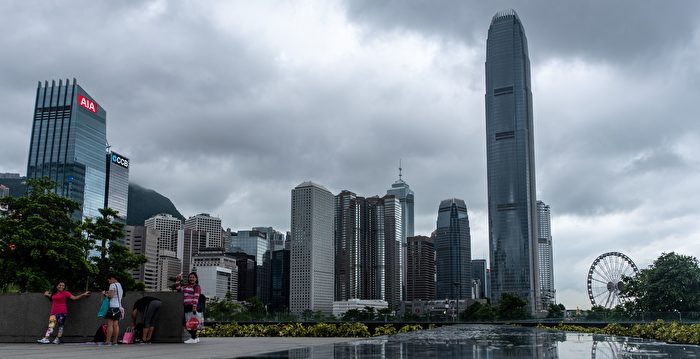 People rest at Tamar in Admiralty with the skyline of Hong Kong's financial district on August 11, 2018. (Photo by Philip FONG / AFP) (Photo credit should read PHILIP FONG/AFP/Getty Images)