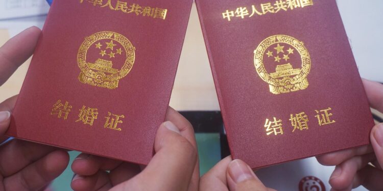 HANGZHOU, CHINA - MAY 20, 2024 - A couple receives a marriage certificate at the Xiaoshan District Marriage Registration office in Hangzhou, capital of East China's Zhejiang province, May 20, 2024. (Photo credit should read CFOTO/Future Publishing via Getty Images)
