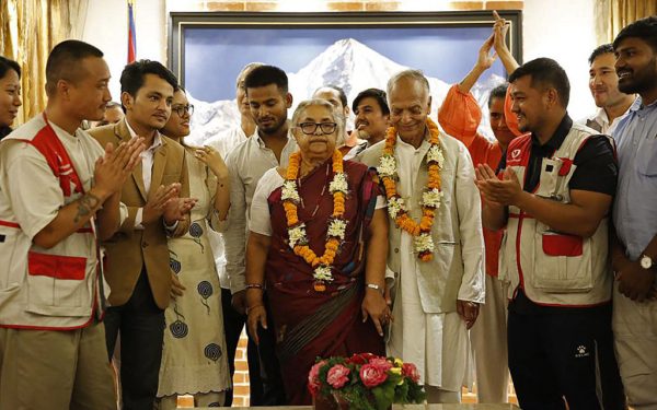 Nepal's newly appointed Prime Minister Sushila Karki (C) is congratulated by her supporters after the swearing-in-ceremony at the President House in Kathmandu on September 12, 2025. Nepal's former chief justice Sushila Karki was sworn on September 12 to lead the transition as the country's next prime minister after deadly anti-corruption protests ousted the government. (Photo by Sujan GURUNG / AFP) (Photo by SUJAN GURUNG/AFP via Getty Images)