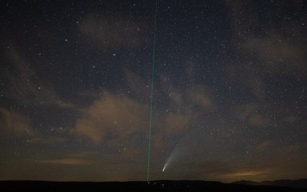 A picture taken on July 15, 2020 shows the C/2020 F3 comet (C), also known as "NEOWISE", and the green laser beam used by the Haute-Provence Observatory to point celestial objects for studies and researches (L) in Saint-Michel-L'Observatoire, southern France. - The Northern Hemisphere's skies offer this summer the beautiful spectacle of a comet, named "NEOWISE", whose exceptionally bright plume is visible to the naked eye, a phenomenon that has not happened for more than 20 years. The comet was discovered by NASAs Near-Earth Object Wide-field Infrared Survey Explorer satellite, or NEOWISE, on March 27, 2020. (Photo by CLEMENT MAHOUDEAU / AFP) (Photo by CLEMENT MAHOUDEAU/AFP via Getty Images)