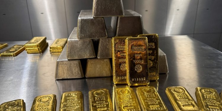 Gold and silver bars are stacked in the safe deposit boxes room of the Pro Aurum gold house in Munich, Germany, October 13, 2025. REUTERS/Angelika Warmuth