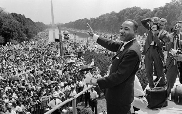 The civil rights leader Martin Luther King (C) waves to supporters 28 August 1963 on the Mall in Washington DC (Washington Monument in background) during the "March on Washington". - King said the march was "the greatest demonstration of freedom in the history of the United States." Martin Luther King was assassinated on 04 April 1968 in Memphis, Tennessee. James Earl Ray confessed to shooting King and was sentenced to 99 years in prison. King's killing sent shock waves through American society at the time, and is still regarded as a landmark event in recent US history. AFP PHOTO (Photo by - / AFP) (Photo by -/AFP via Getty Images)