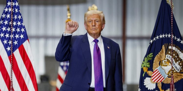 U.S. President Donald Trump makes a fist at the end of an event during a visit to Coosa Steel Corporation, in Rome, Georgia, U.S., February 19, 2026. REUTERS/Kevin Lamarque