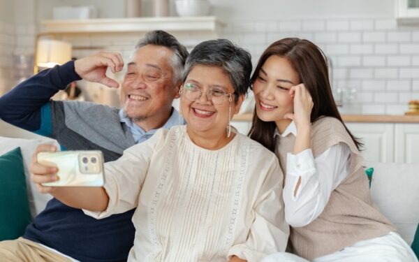 asian beautiful daughter and senior father and mother enjoying conversation and good time at home.happiness family and holiday at home,mother day concept.loving asian adult daughter sitting on couch